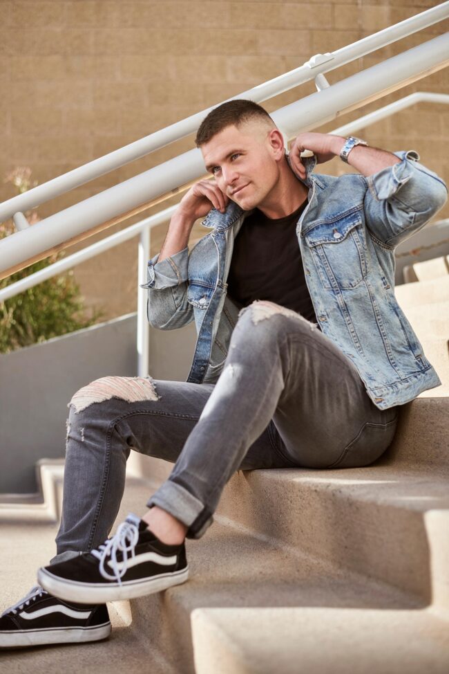 Lifestyle dating profile photo for men, casual seated portrait with denim jacket for dating apps, natural profile image for Hinge, Bumble, Tinder, and online dating profiles