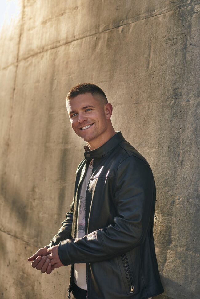 Confident dating profile photo for men, stylish outdoor portrait with leather jacket for dating apps, natural profile image for Hinge, Bumble, Tinder, and online dating profiles