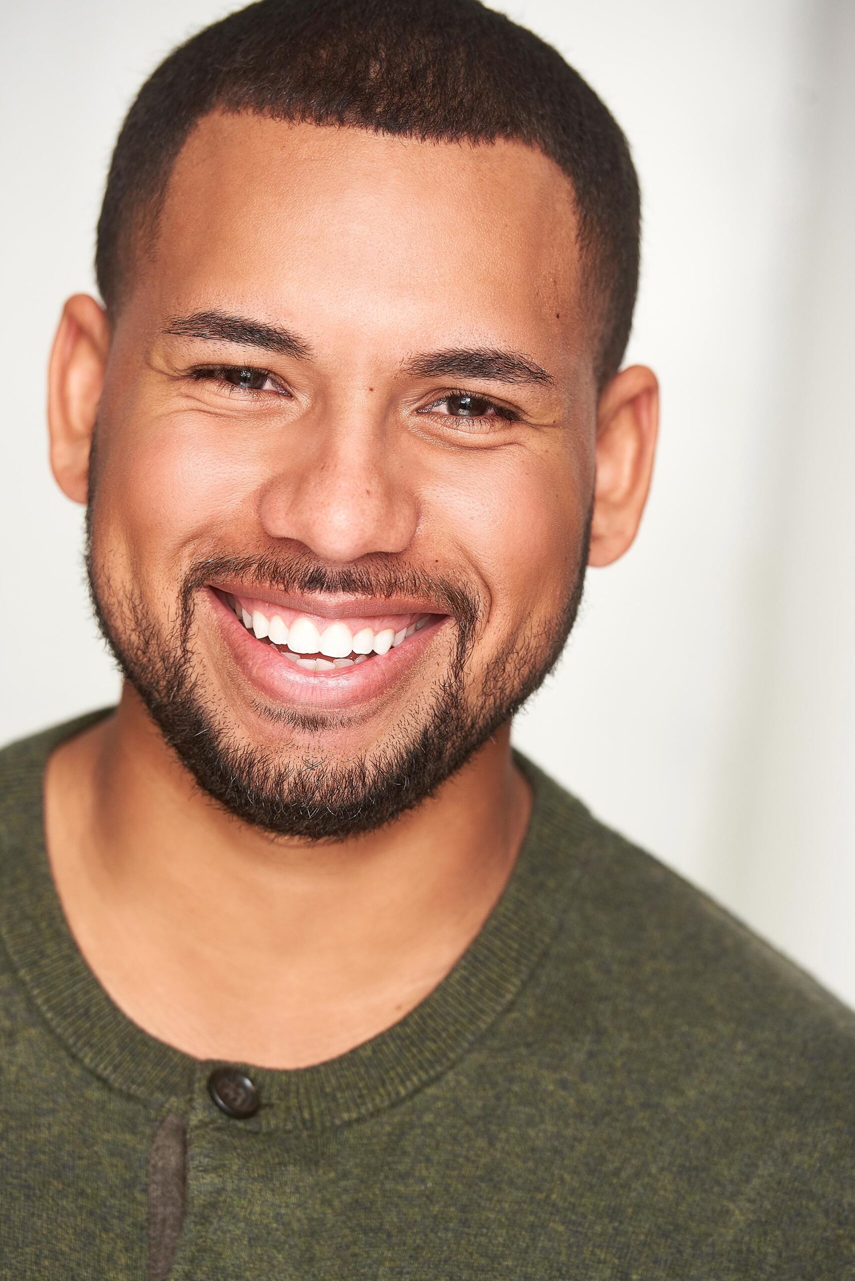 Actor posing for commercial headshots showing versatile expressions, Bright and engaging commercial headshots for aspiring actors, Professional commercial headshots capturing a performer's charisma, Close-up of an actor in a commercial headshots session, Commercial headshots showcasing an actor's friendly demeanor, Actor’s headshot with a natural, approachable look for commercial casting, Vibrant commercial headshots reflecting an actor's on-screen potential, Expressive commercial headshots for a television series audition, Headshot of an actor with a dynamic commercial look, Actor in a studio for commercial headshots highlighting their unique style