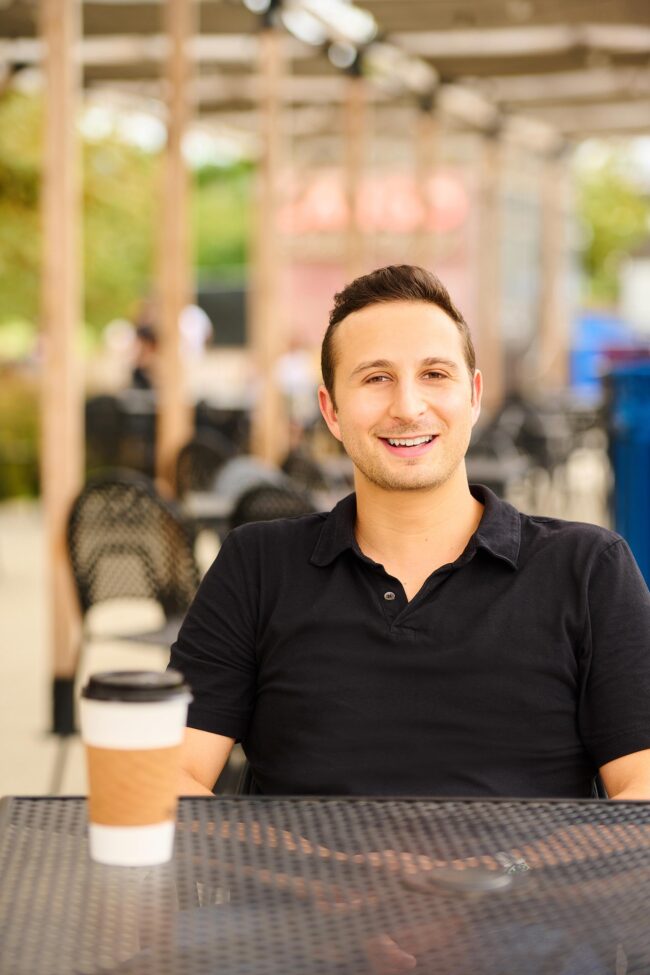Coffee shop dating profile photo for men, casual seated lifestyle portrait for online dating profiles, approachable image for Hinge, Bumble, Tinder, and matchmaking platforms