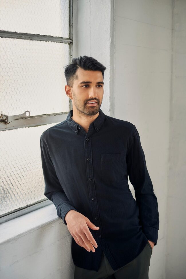 Modern dating profile photo for men, indoor lifestyle portrait with natural window light for online dating profiles, polished image for Hinge, Bumble, Tinder, and matchmaking platforms
