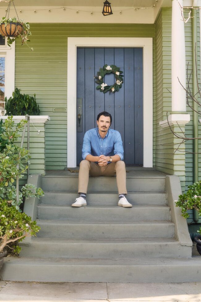 Casual dating profile photo for men in San Francisco, Man seated on front steps in a relaxed neighborhood setting, Natural online dating photo with approachable style and casual wardrobe, San Francisco dating app photographer image for Hinge Bumble and Tinder profiles.