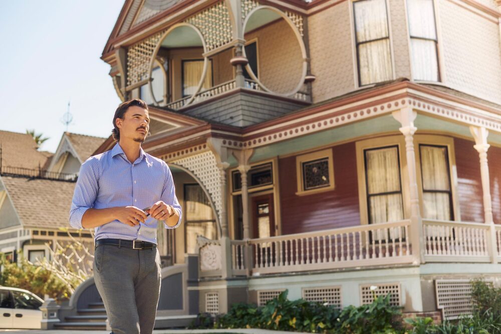 Neighborhood dating profile picture for men in San Francisco, Man in a button down shirt walking near a classic city home, Natural dating app photo that shows personal style and a relaxed lifestyle, San Francisco dating photographer image for Hinge Bumble and Tinder profiles.