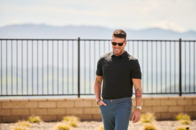 Outdoor realtor lifestyle photo in Los Angeles, professional man walking near a scenic residential view, approachable image for realtor website, Zillow profile, social media, marketing, and personal branding