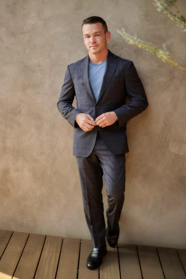 Realtor branding photo in Los Angeles, professional man in suit photographed against a clean interior wall, polished image for realtor website, Zillow profile, social media, marketing, and personal branding