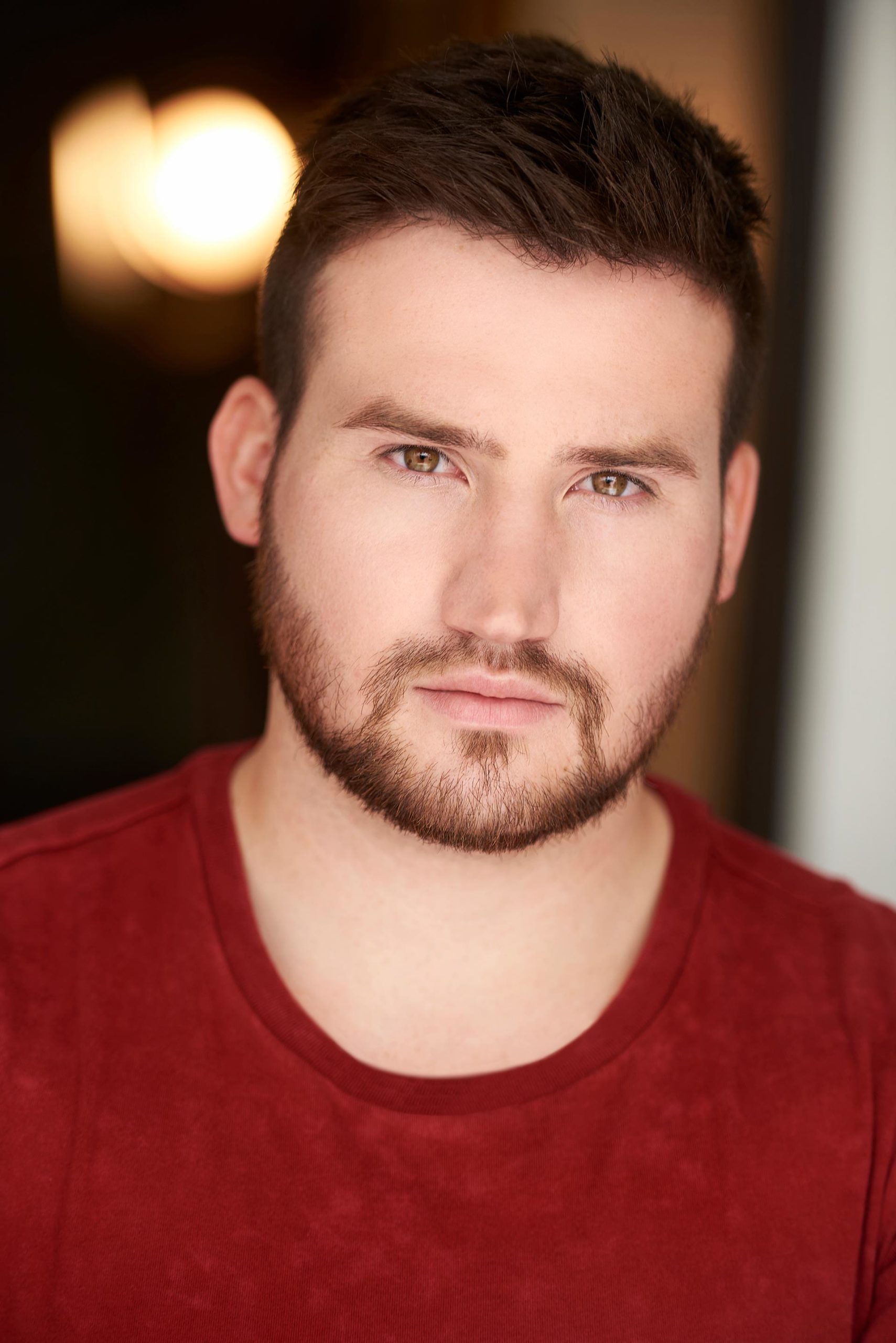 Professional Acting Headshots: Capturing Your Theatrical Persona Actor posing for professional acting headshots, Theatrical headshot session with a professional photographer, Close-up of an actor's expressive face in a headshot, Professional acting headshots showcasing dramatic talent, Actor preparing for a headshot that reflects theatrical range, Intense and character-driven acting headshot, Professional headshots capturing an actor's versatility, Emotional expression in a professional acting headshot, Striking headshots for actors looking to stand out, Actor in a headshot session emphasizing their stage presence