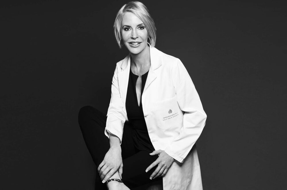 Professional headshot in Los Angeles, black and white portrait of a healthcare professional in a white coat, useful for website bio, professional profile, press feature, company profile, and online presence