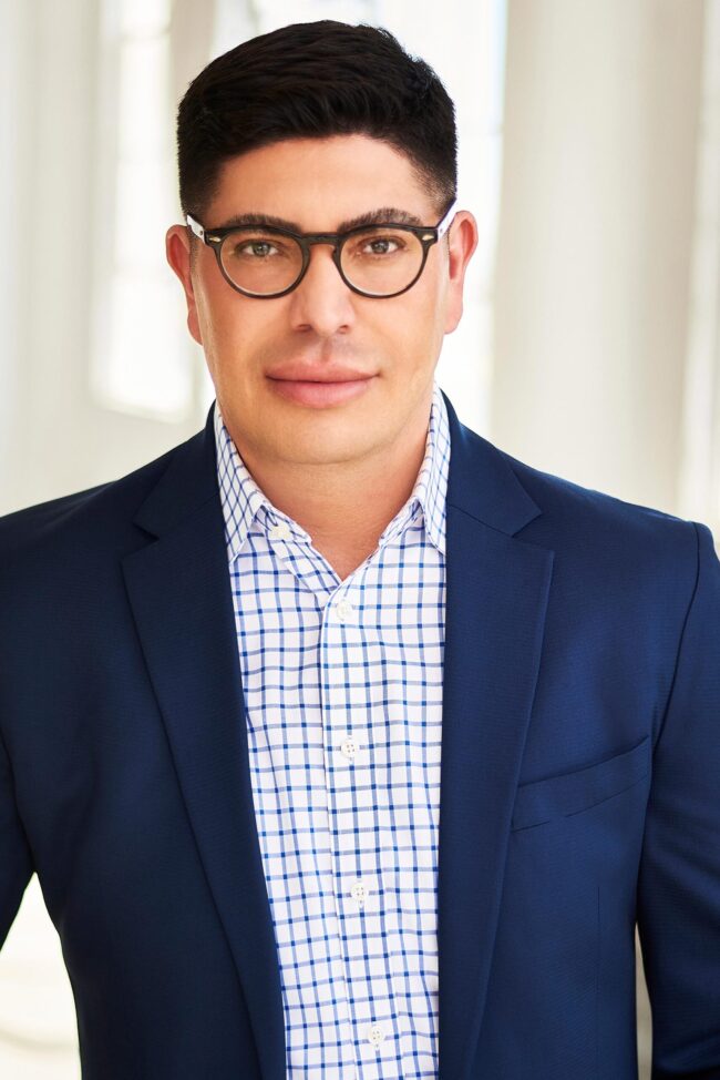 Professional headshot in Los Angeles, close-up portrait of a man in a blue blazer and glasses, useful for website bio, LinkedIn profile, resume, company profile, and professional use