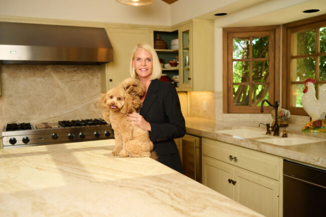 Realtor lifestyle photo in Los Angeles, professional woman photographed in a home kitchen with two small dogs, approachable image for realtor website, social media, marketing, and personal branding