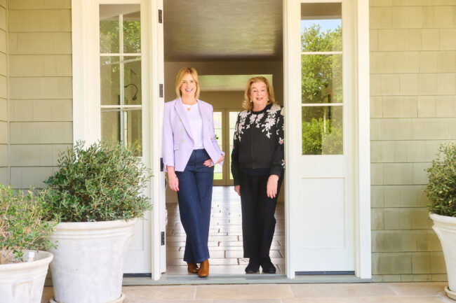 Realtor team lifestyle photo in Los Angeles, two real estate professionals photographed in the doorway of a residential home, polished image for brokerage website, team bio, social media, marketing, and client trust
