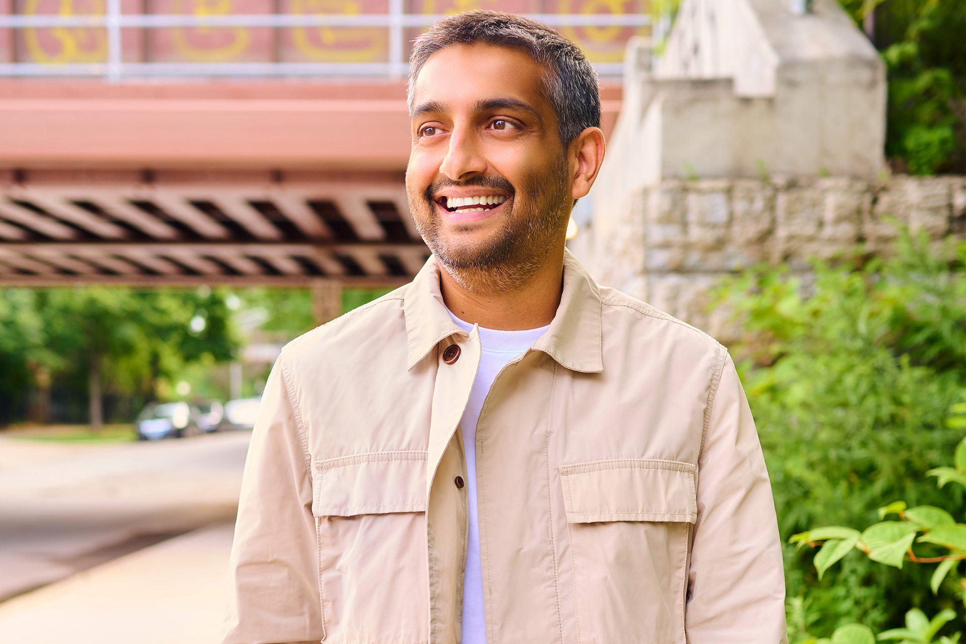 Creating the Best Dating Profile for Men Man smiling outdoors in a natural lifestyle photo for a dating profile.