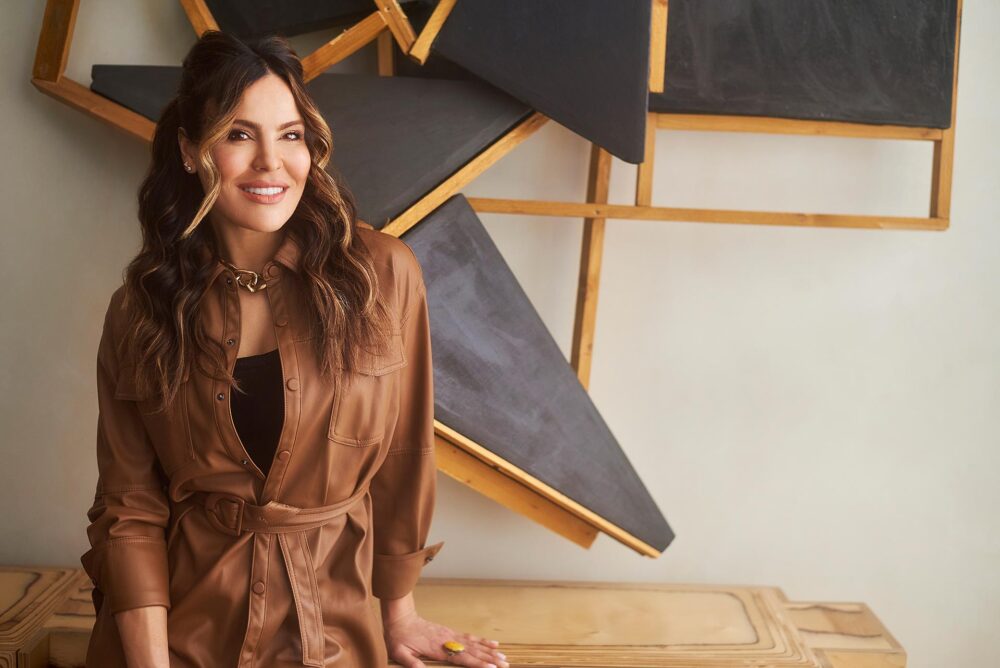 Creative executive portrait in Los Angeles, professional woman in brown jacket photographed in a modern interior setting, LinkedIn and website bio image
