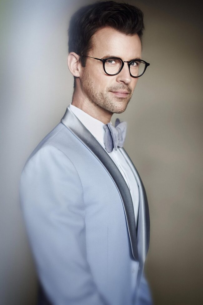 Editorial executive portrait in Los Angeles, professional man in gray tuxedo jacket and glasses, modern business profile image for LinkedIn, website bio, and professional use