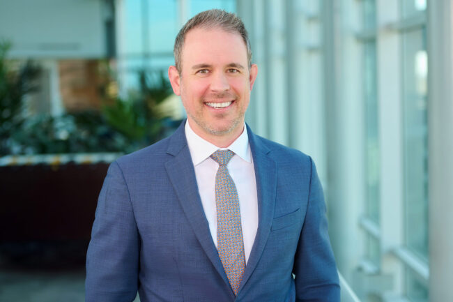 Executive office headshot in Los Angeles, professional business portrait with blue suit in a modern office setting, LinkedIn and company website profile image