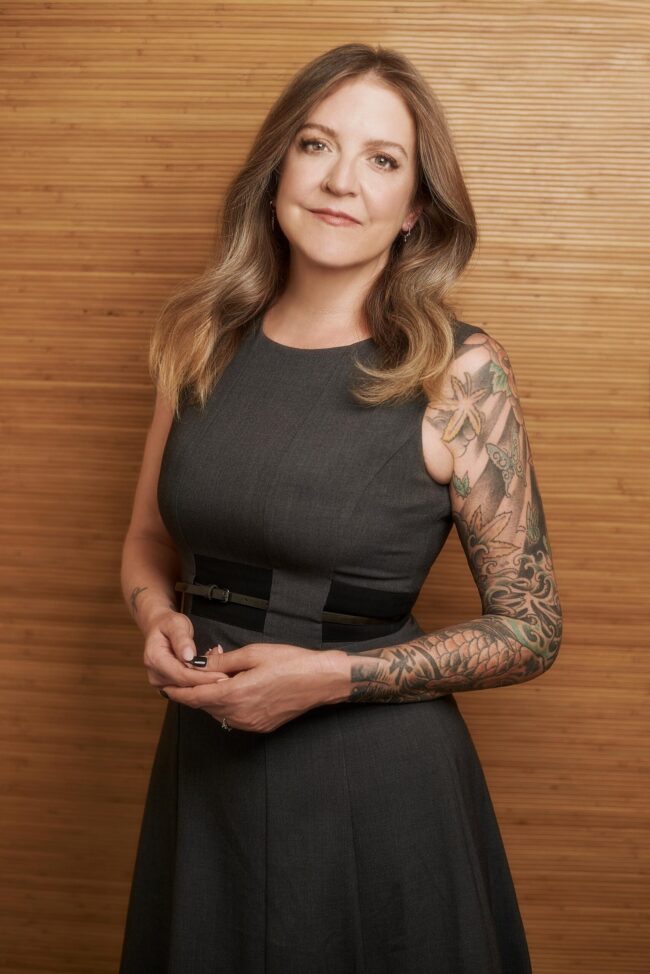 Los Angeles photographer professional branding portrait, woman in a gray dress photographed against a warm wood background for websites, bios, profiles, press, and online presence