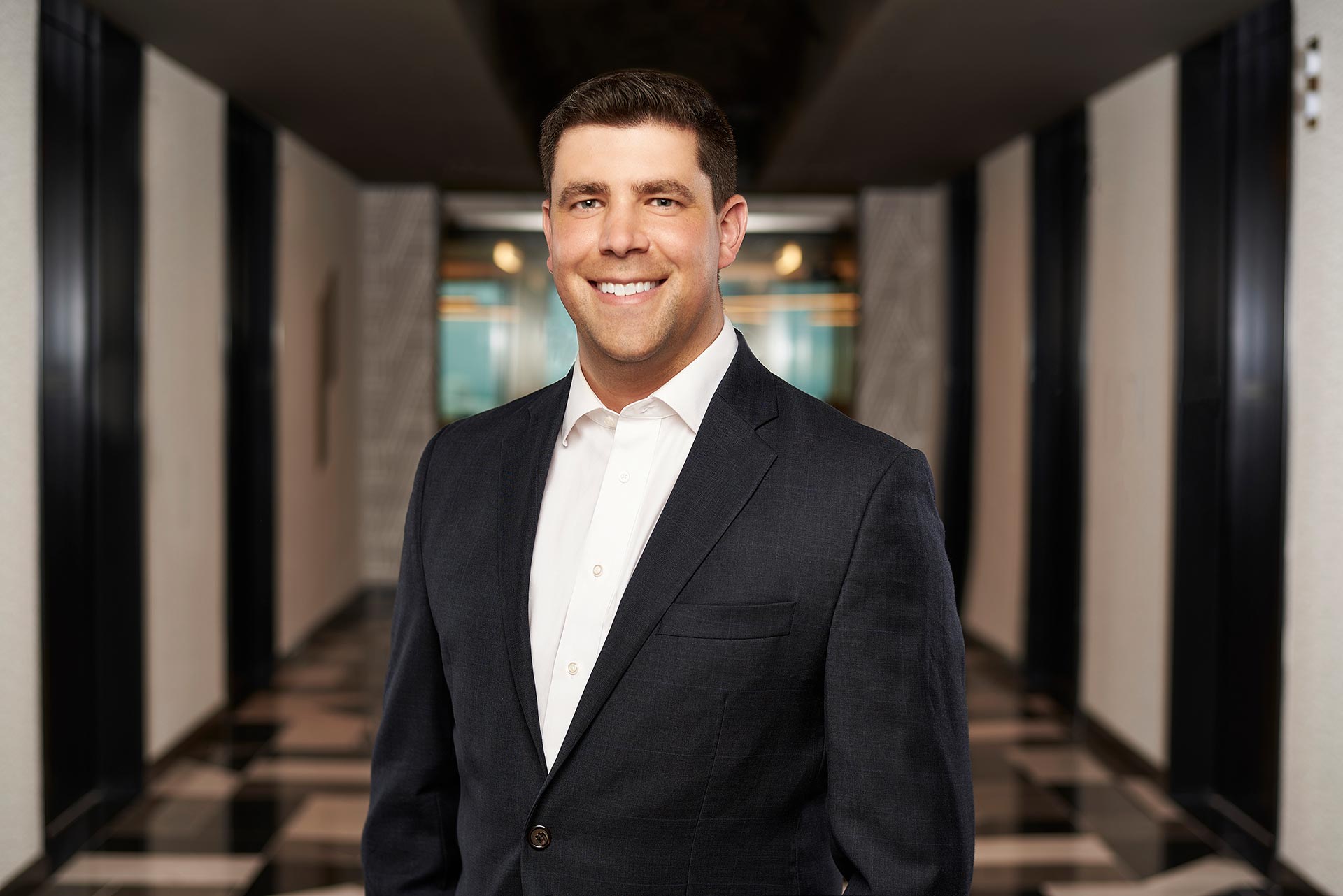 Professional Headshot by Los Angeles Photographer Los Angeles photographer professional headshot, man in a suit photographed in a modern lobby setting for websites, LinkedIn profiles, bios, resumes, and professional use
