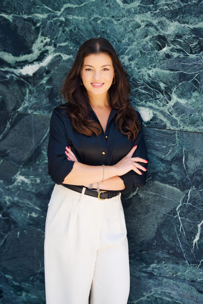 Realtor branding photo in Los Angeles, professional woman photographed against a marble wall, polished image for realtor website, Zillow profile, social media, marketing, and personal branding