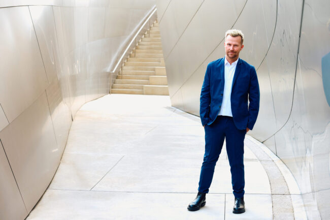 Realtor branding photo in Los Angeles, professional man in blue suit photographed in a modern architectural setting, polished image for realtor website, Zillow profile, social media, marketing, and personal branding