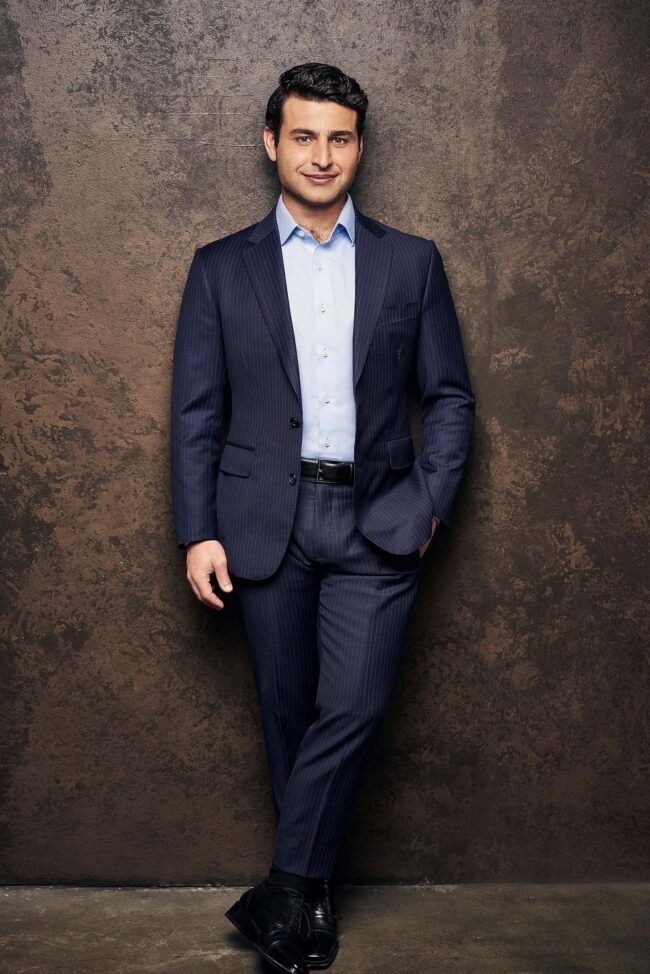 Modern executive business portrait in Los Angeles, professional man in navy suit against textured studio background, LinkedIn, company website, and executive bio image