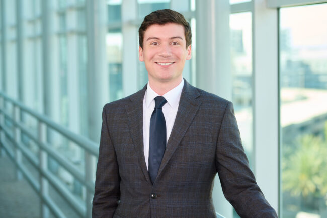 Office corporate headshot in Los Angeles, professional business portrait with gray suit and blue tie in a modern office setting, LinkedIn and company website profile image