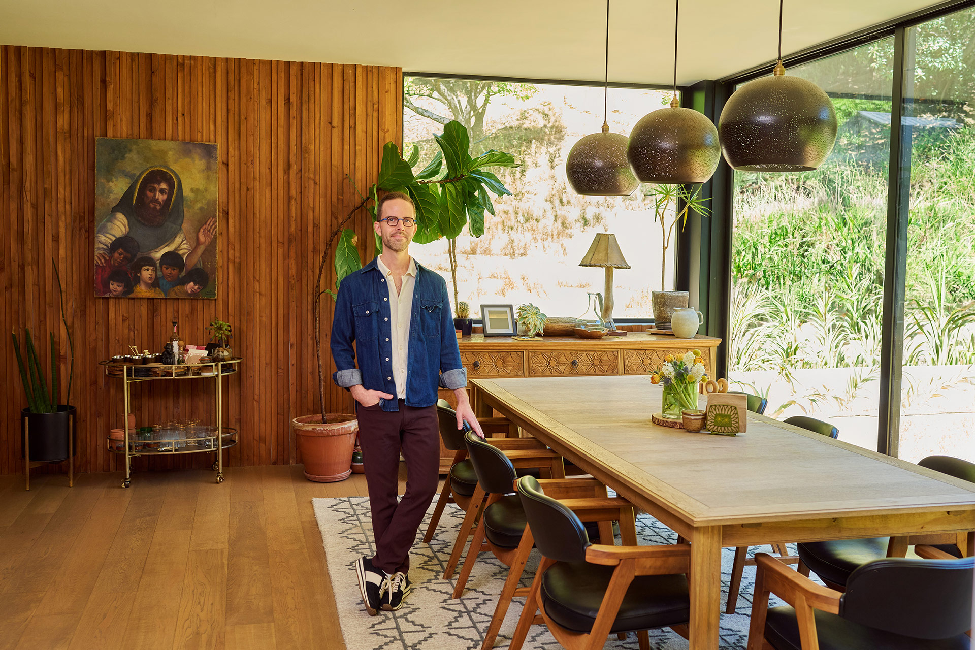 Best Dating Photos for Guys Man standing in a stylish home interior for a natural dating profile lifestyle photo.